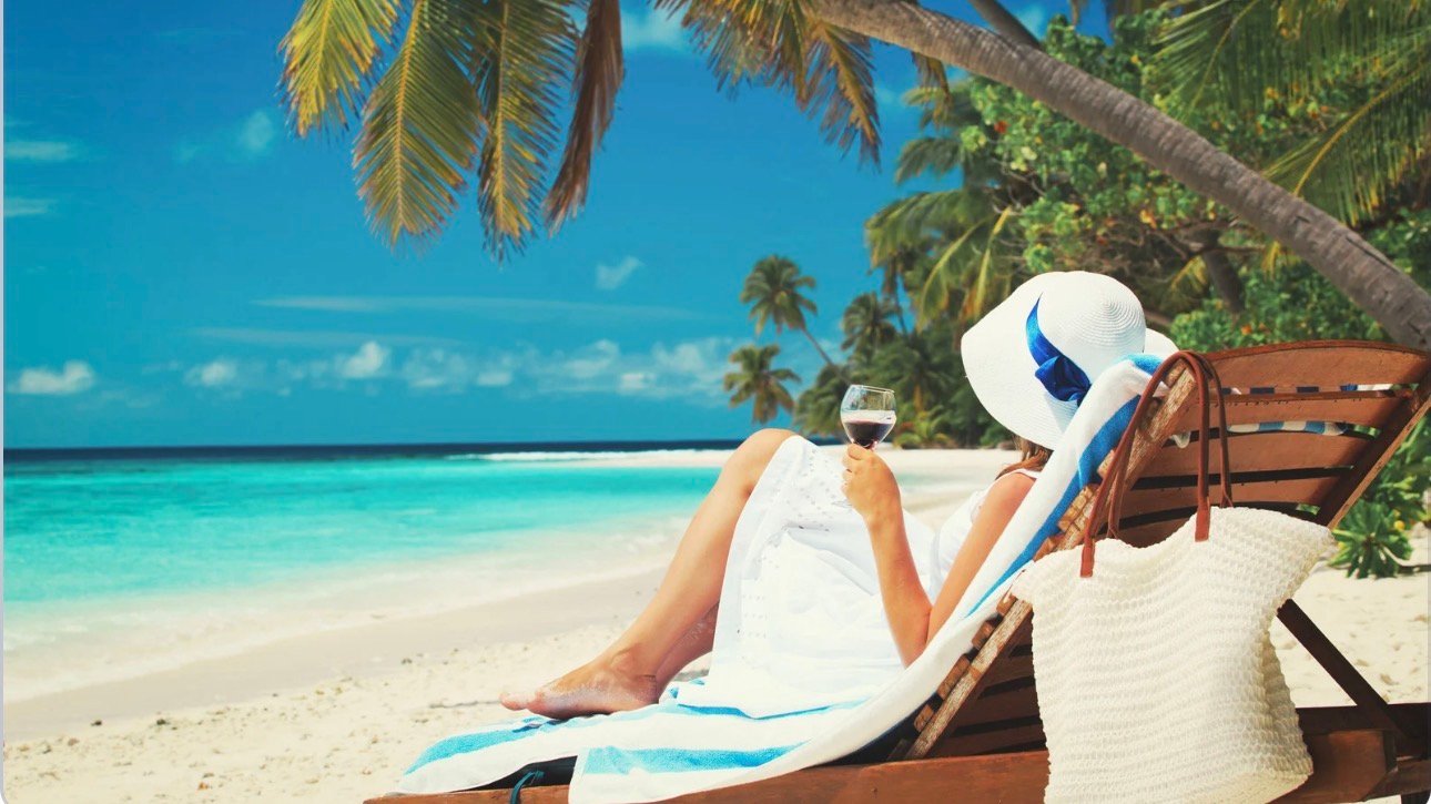 Woman relaxing under umbrella